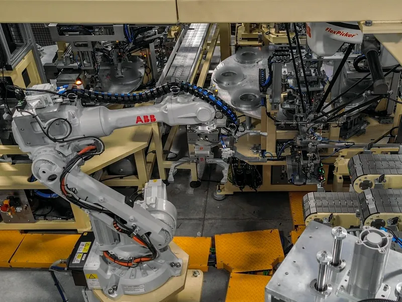 ABB FlexPicker delta robot, six-axis ABB robot and flat-top chain conveyors on an assembly line built by AMD Machines