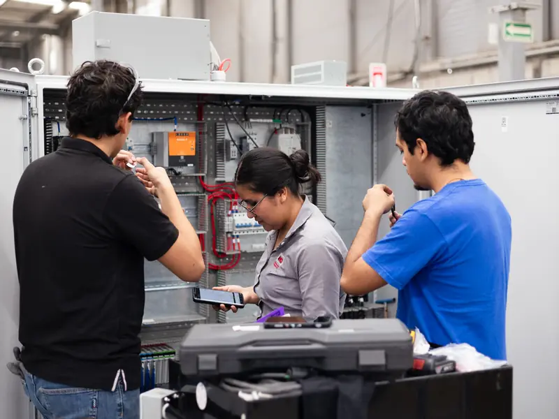 AMD Machines engineers commissioning an electrical control panel