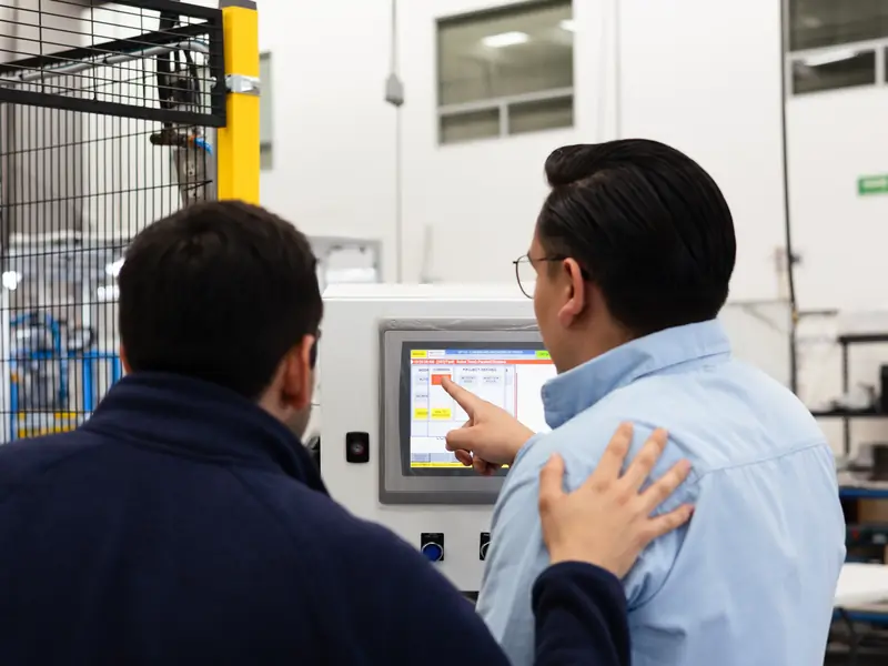 AMD Machines engineers reviewing a machine HMI screen
