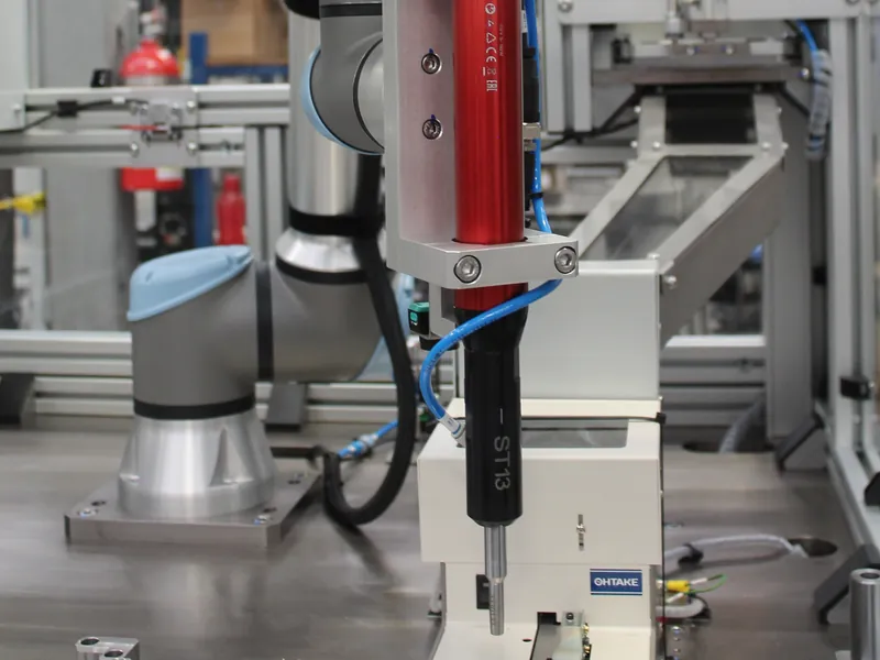 Cobot screwdriving station with the spindle bit just above an Ohtake screw feeder, built by AMD Machines