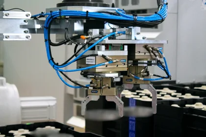 Automated material handling system with conveyor and robotics