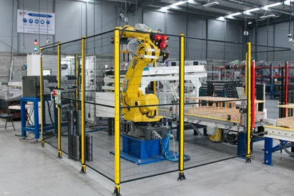 Custom robotic cell with industrial robot for automated manufacturing